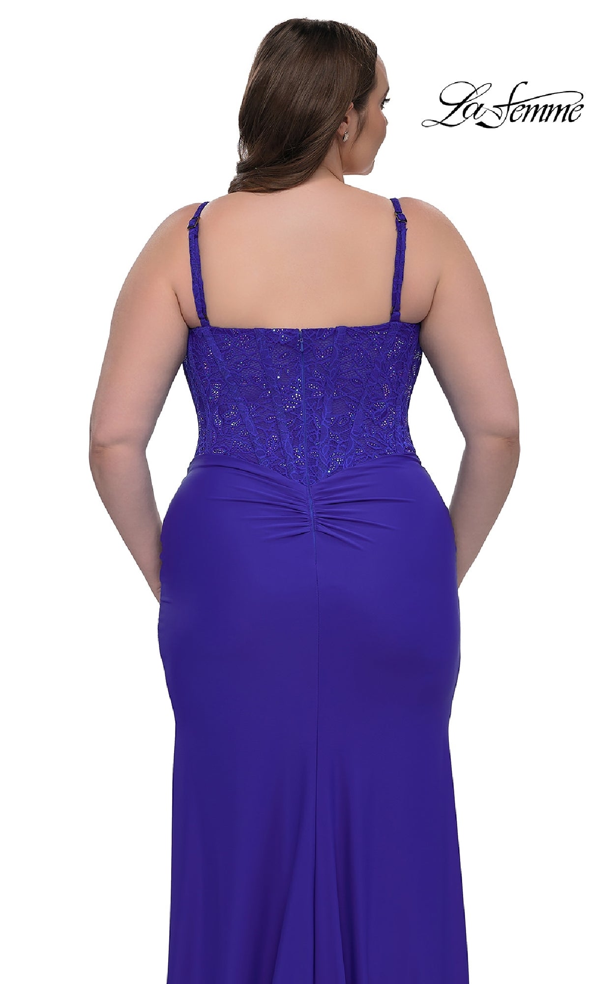 A woman models the Plus-Size Long Corset Prom Dress La Femme 32449 in royal blue, featuring lace bodice details and adjustable straps, displayed from the back.